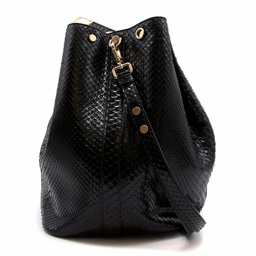 Christian Dior large 'Diorific' shiny python bucket bag. 
Made in Italy. 
Dior Spring/Summer 2014 Collection. 

Gold metal handle. 
Features hand- embroidered badges and Dior charm. 
Features an additional small clutch within interior. 
Includes