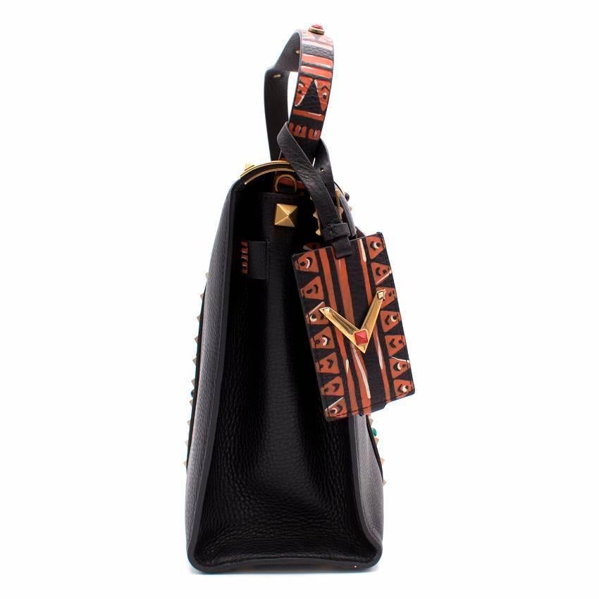 Valentino Black Painted My Rockstud Top Handle Bag.
Hand-painted tribal pattern detailed with stones.

Snap flap closure. 
Two-tone pattern.
Detachable long strap. 
Gold metal accents.
Internal zip pocket.
Made in Italy.
 
Approx Measurements: