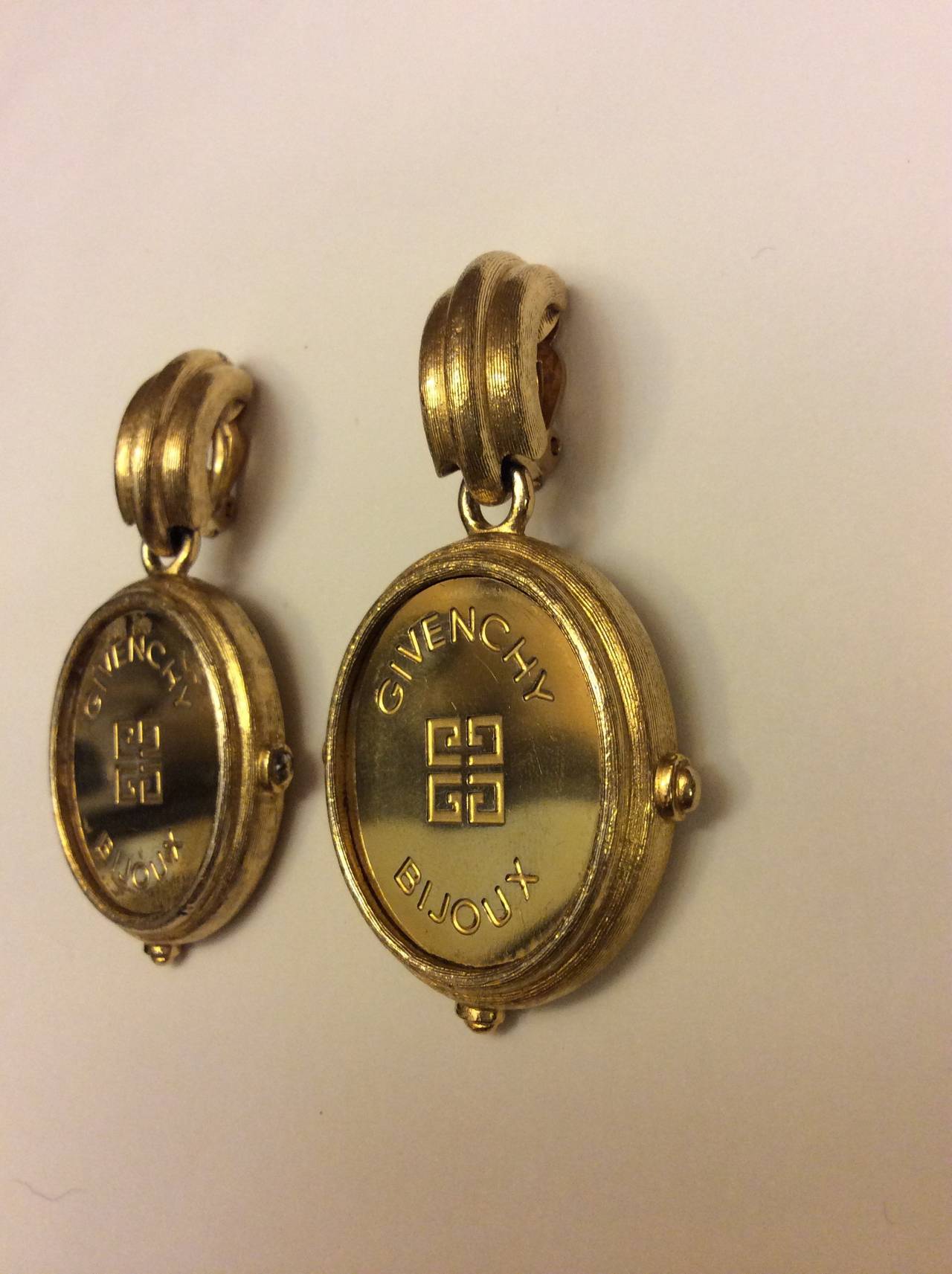 Vintage gorgeous Givenchy gold tone with deliberate distress clip on dangle earrings. 2.5