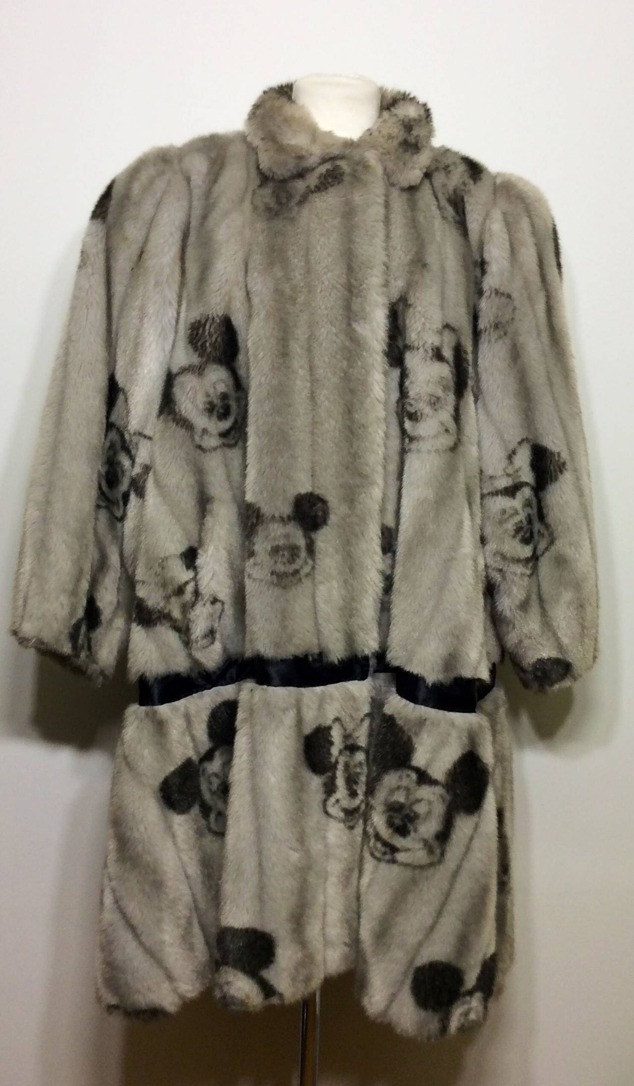 Vintage Minnie & Mickey Mouse grey faux fur coat from Apparence France. This ultra soft faux fur was created as part of a limited collection.  The coat features dual waist level pockets and front closures. 
Fully lined. 
Made in France

Underarm