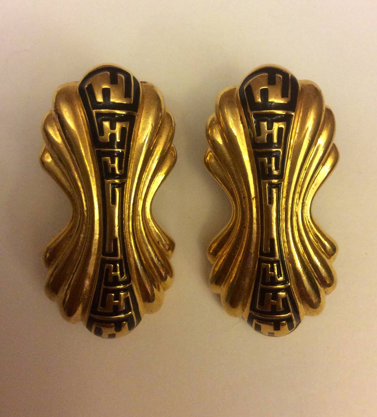 Classic Fendi Grecian gold post earrings with black Logo design.
1 3/4