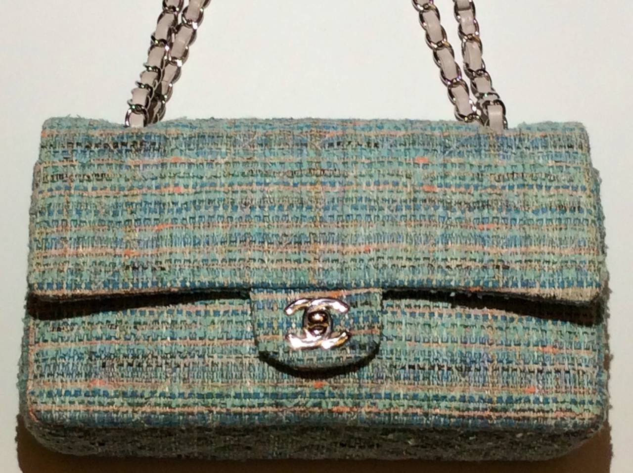 Chanel 2.55 quilted tweed double flat leather lined handbag with silver hardware and alabaster white leather shoulder straps.  The most beautiful color combination of blues, turquoise, peach, white. Will work with simply most solid colors.  Serial