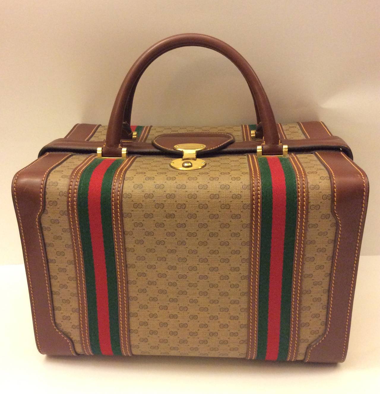 This is an authentic GUCCI Vintage Monogram Train Case. The classic features and fine quality of this vintage Gucci train case make this sophisticated for travel. The case has a beautiful, distinctive structure and is crafted of classic Gucci GG