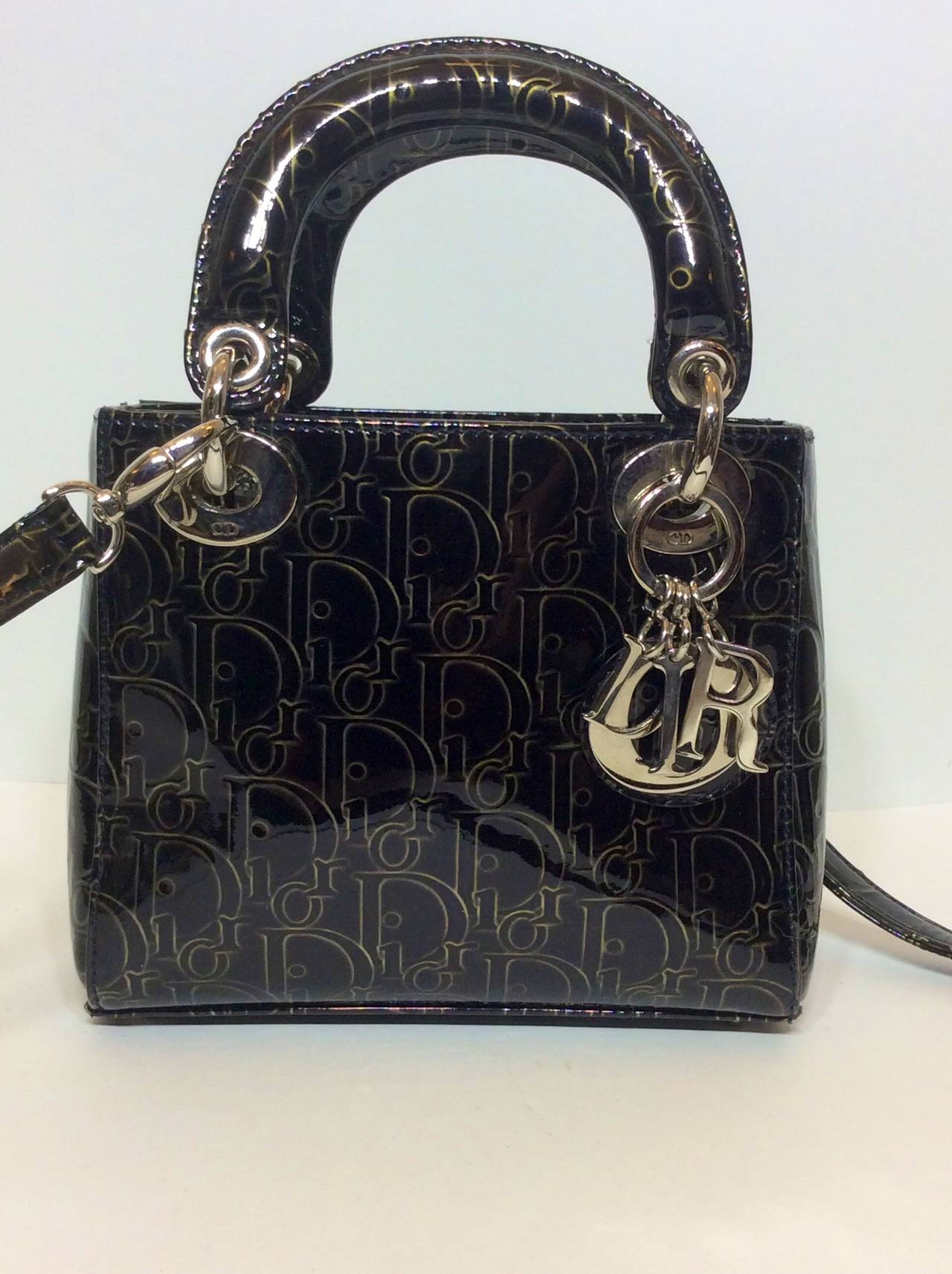 This is a gorgeous Christian Dior Rare Mini Lady Dior Gold Monogram Black Patent Leather Top Handles Handbag with optional shoulder strap.
Top flap with magnetic snap closure
One zipper slot interior pocket
Measurements: 
6