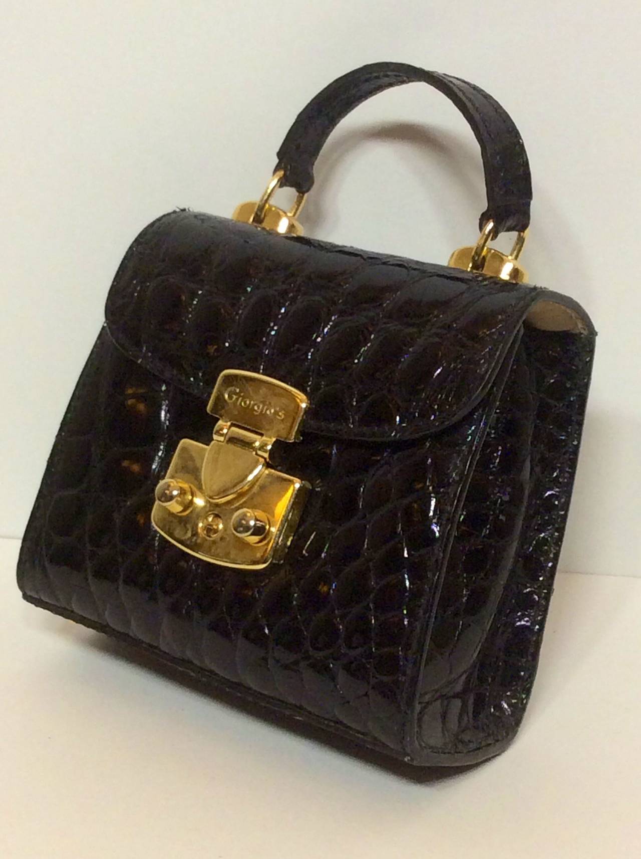 This is a sweet rare Giorgio's Palm Beach Baby Kelly black gator handbag with gold hardware and optional shoulder or cross body strap. Immaculate condition!
Measures:
4.5