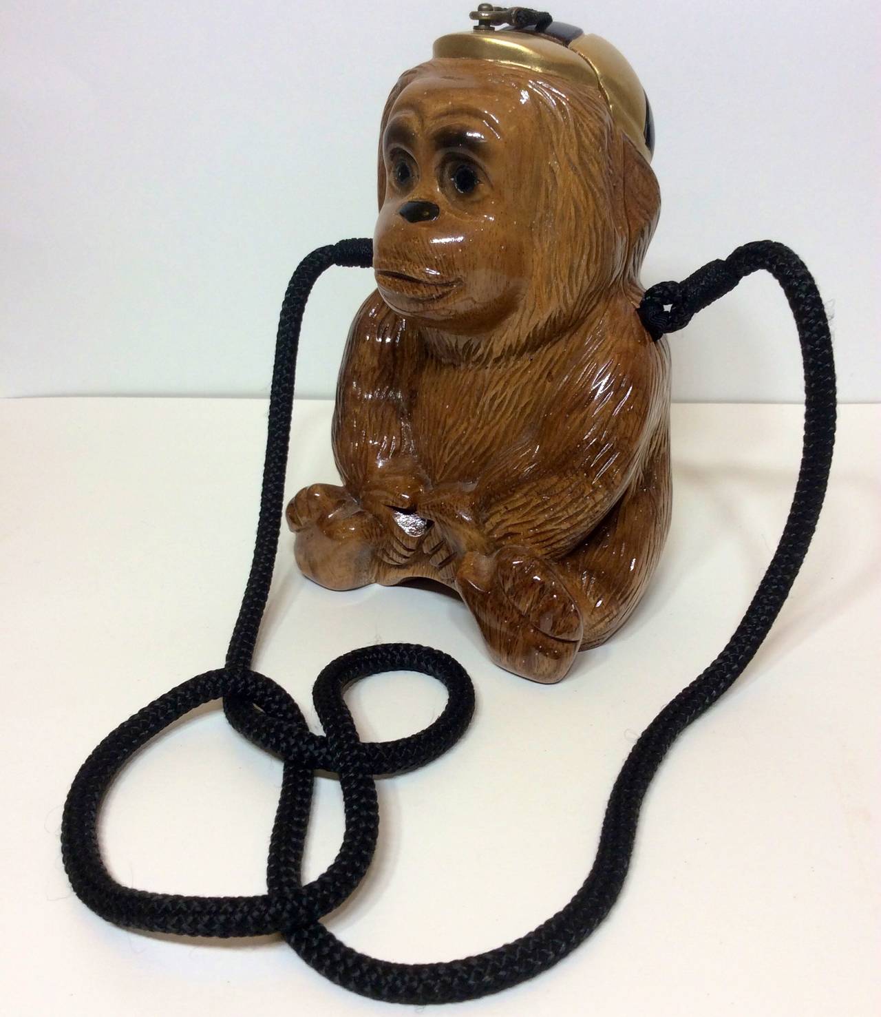 This is a fun and rare Timmy Woods Beverly Hills Collection wooden carved monkey with cap handbag  can be utilized as a clutch by tucking in black shoulder strap. 
Measurements:
9