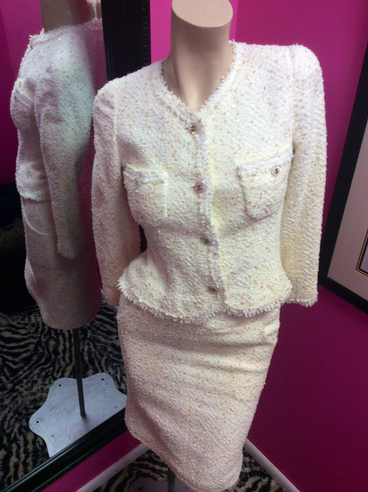 This is a gorgeous vintage 1997 Chanel ivory boucle tweed jacket and skirt suit with Lesage sequins all over.  Fully lined button up longsleeve jacket with traditional silver chain on the interior. 
Jacket measurements are: 
 bust 30-33