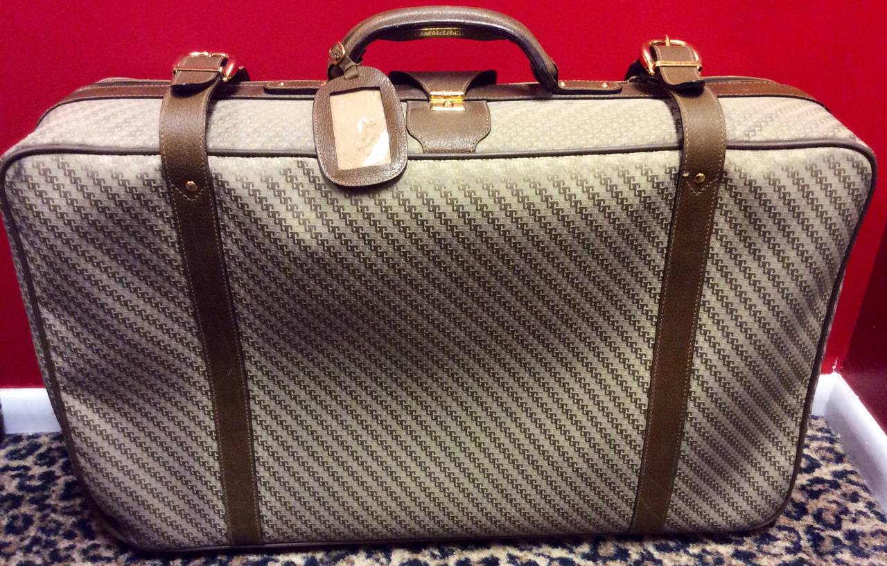 Thus is a vintage Gucci monogram canvas luggage with brown leather trim and handle. 
Measurements:
29