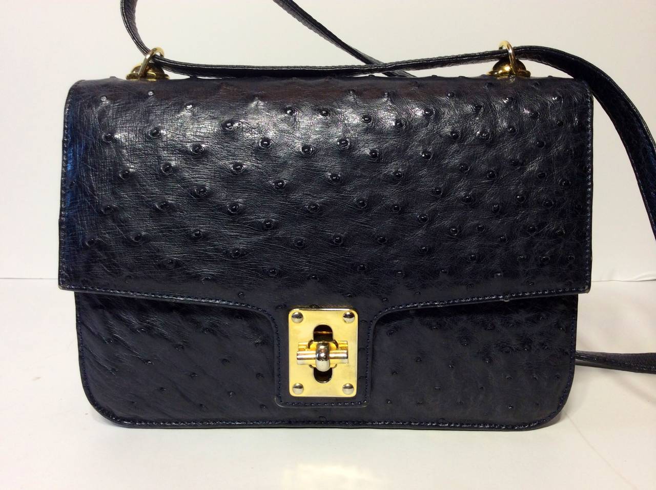 This is a rare Giorgio's Palm Beach ostrich navy slate blue two compartment flap handbag. Adjustable cross body shoulder strap.  One exterior slot pocket.  One interior zipper compartment. Excellent condition. Minor hardware tarnish.