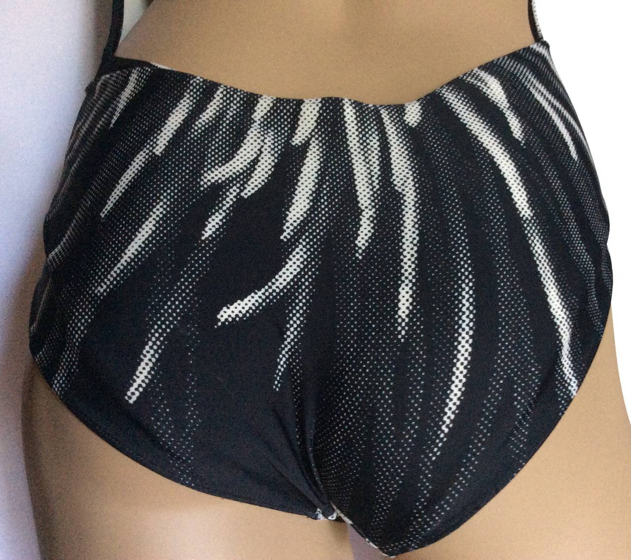 This ia a rare Hermes Paris low plunging monokini black and white bathing suit. 
Signature H silver hardware at neck and at attached wrap. 
Size 38
Bust up to 36