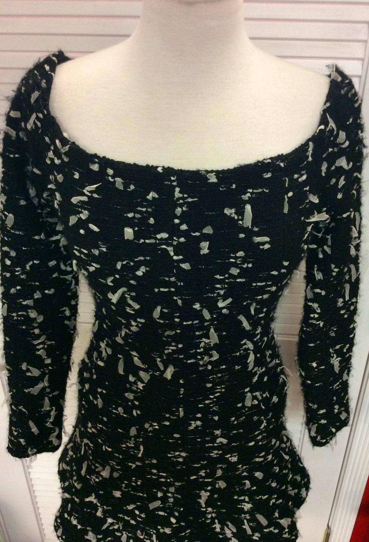 This is a Chanel 02A  2002 tulle  confetti tweed semi off shoulders long sleeve mini dress
Wool blend fully lined
Hidden back zipper
A Line
Fabric composition: 72% wool, a percent nylon, a percent acrylic, 7% rayon
Lining 90% silk temper sent