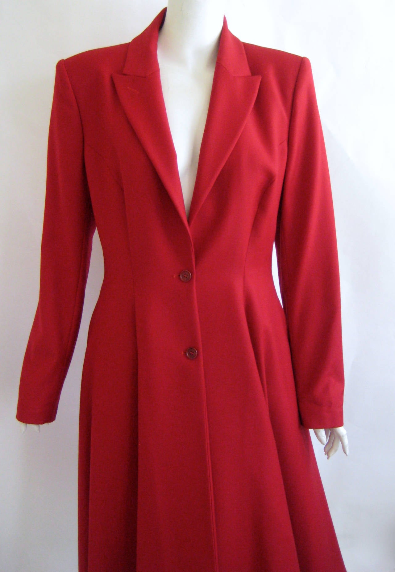 Stunning and rare Alexander McQueen coat that dates to 1998-1999.This is made of a fine red wool .It nips in at the waist and flares out in a cut that is very similar to David Bowies union jack coat.

This has two hidden side pockets and fastens