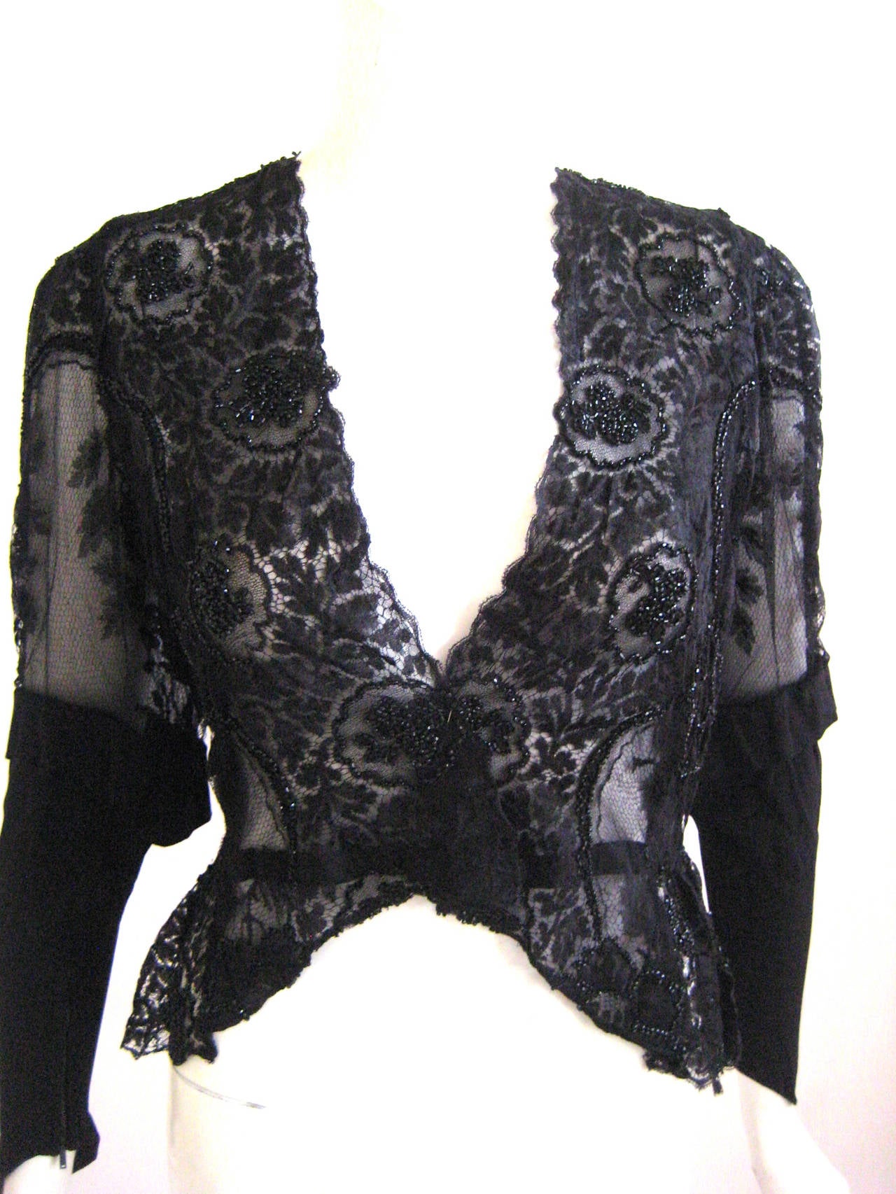 silk chantilly lace 
lined in silk chiffon
silk crepe sleeve with zippers at cuffs 
gorgeous embroidered beadwork