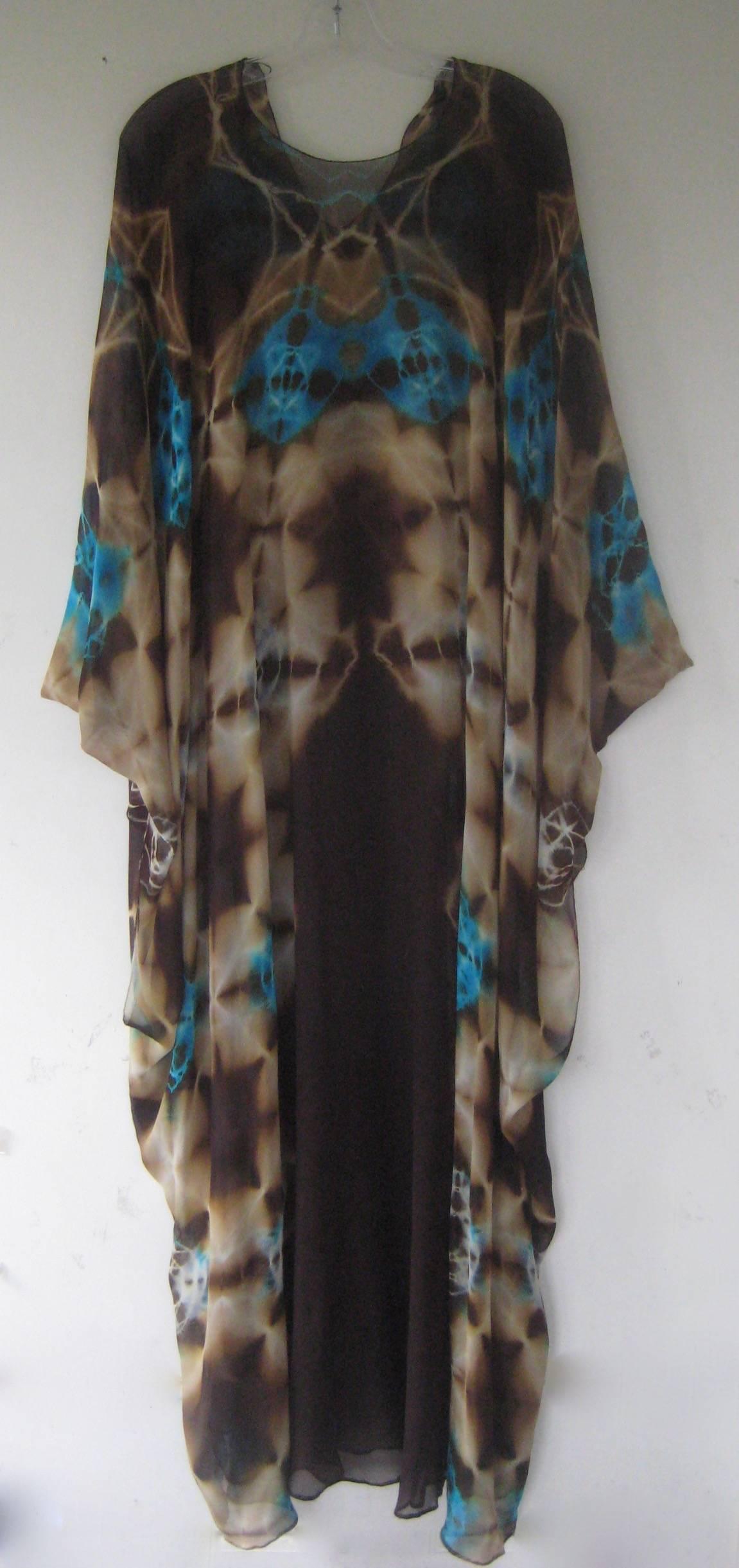 Unbelievably rare Halston piece !
1972 tie dye silk chiffon caftan 
This still has it's matching sleeveless underdress !
Gorgeous colors in blues and browns
Matching underdress is a deep brown ,Photos on the wall show the caftan without the
