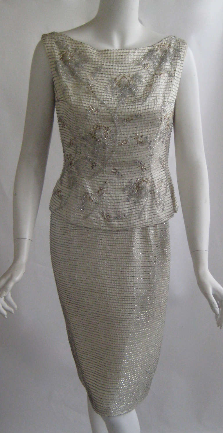 Ceil Chapman Beaded Silk Ensemble
Tight fitting skirt with attached rayon bodice 
Beaded silk overblouse 
Both peices zip up the back
Skirt narrows to 34