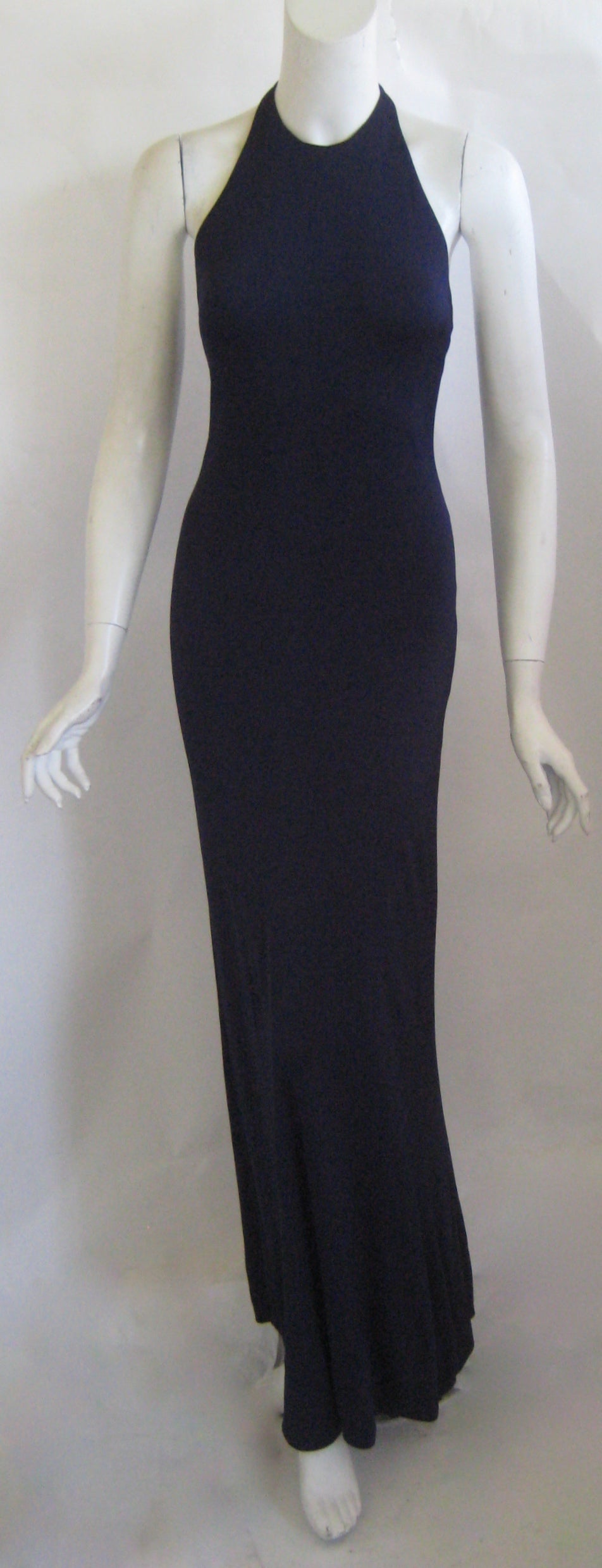 Wonderful deep blue Halston evening gown with matching jacket .This halter gown fastens at the neck with two hooks and thread loops and these are the only closures.The jacket also has no closures and both pieces consist of a double layer of