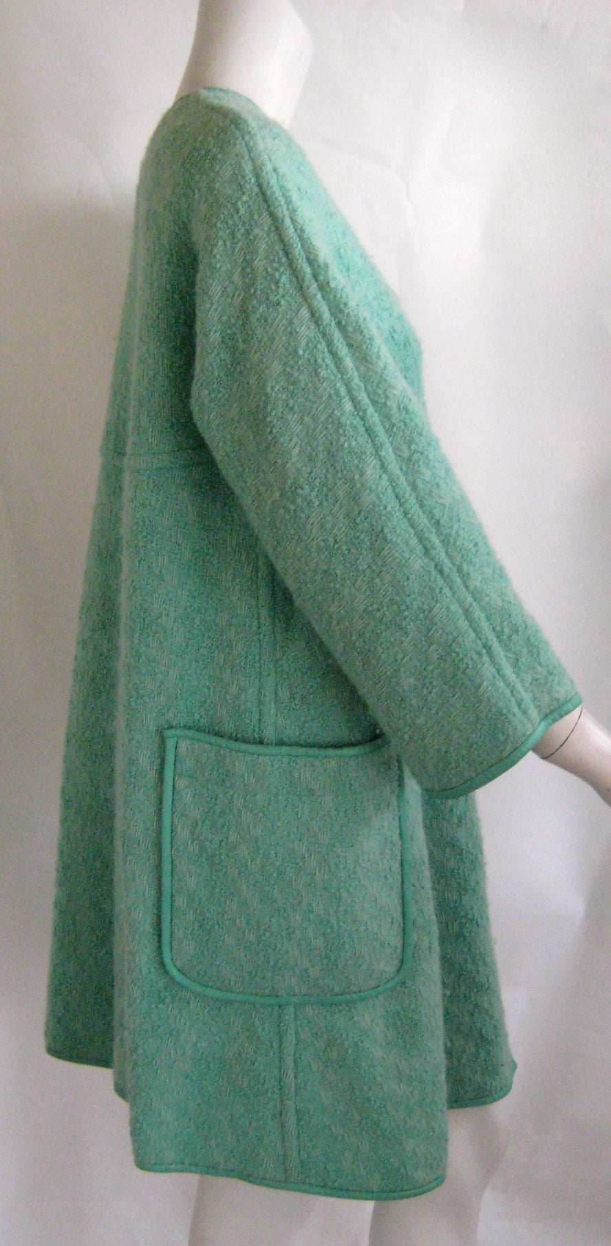 Wonderful vintage Bonnie Cashin coat in a rare and hard to find color .This is made of an aqua boucle wool trimmed in matching leather .It has two large square side pockets that are trimmed in aqua leather and her signature turnlock closures down