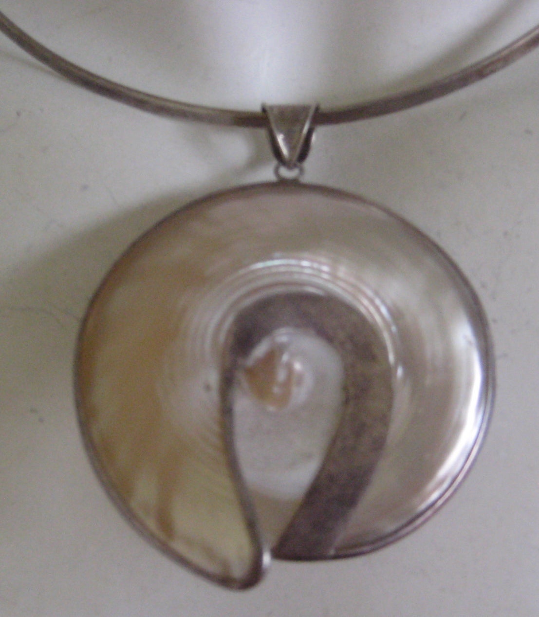 Very pretty shell encased in sterling silver .Sterling collar is stamped 925 James avery and shell pendant is un marked sterling.
This lovely necklace dates to the 1970s and it is in excellent condition
