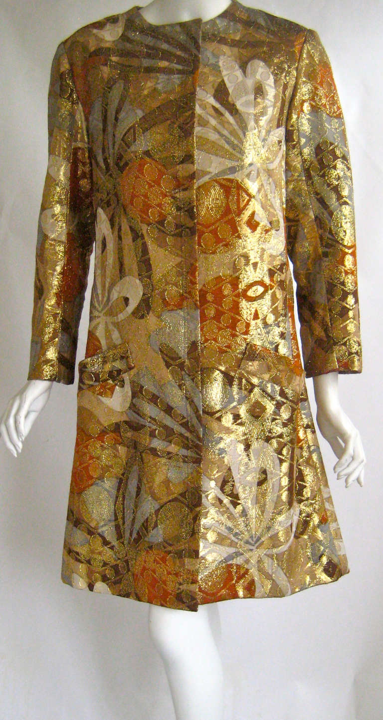 Wonderful piece can be worn as a cocktail dress or an evening coat 
Unlined and faced with taupe silk 
Couture snaps down the front 
2 side slant pockets