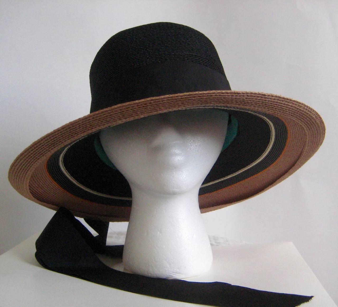 Lovely 1960s Yves Saint Laurent straw hat with a wide striped brim and long ribbon streamers.Signature turquoise grosgrain interior ribbon .Label is missing This perfect summer hat is in excellent condition and it measures 22