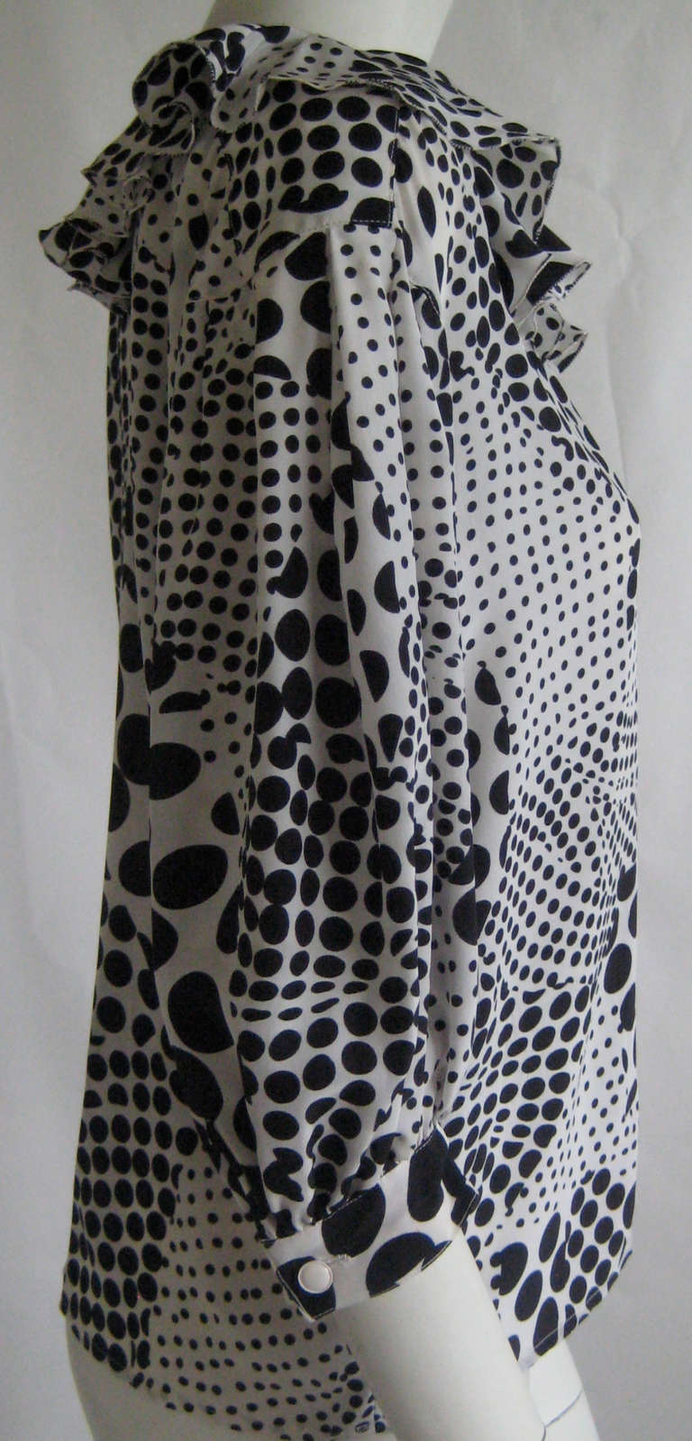 Lovely polka dot blouse
Ruffle at neckline 
100% silk
This slips on over the head with no closures 
3/4 length sleeves with button cuffs