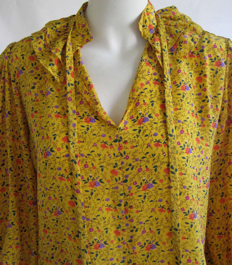 Silk peasant blouse 
Ties at neck 
Ruffle collar
100% silk
Slips on over the head with no closures
Button cuffs