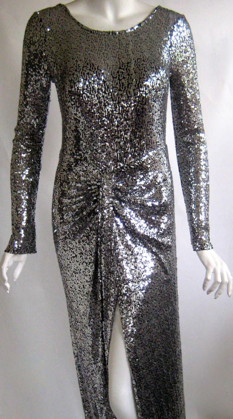 Stunning Sequin Gown 
Slit all the way up the front 
Strapless poly spandex lining  
Zips up the back