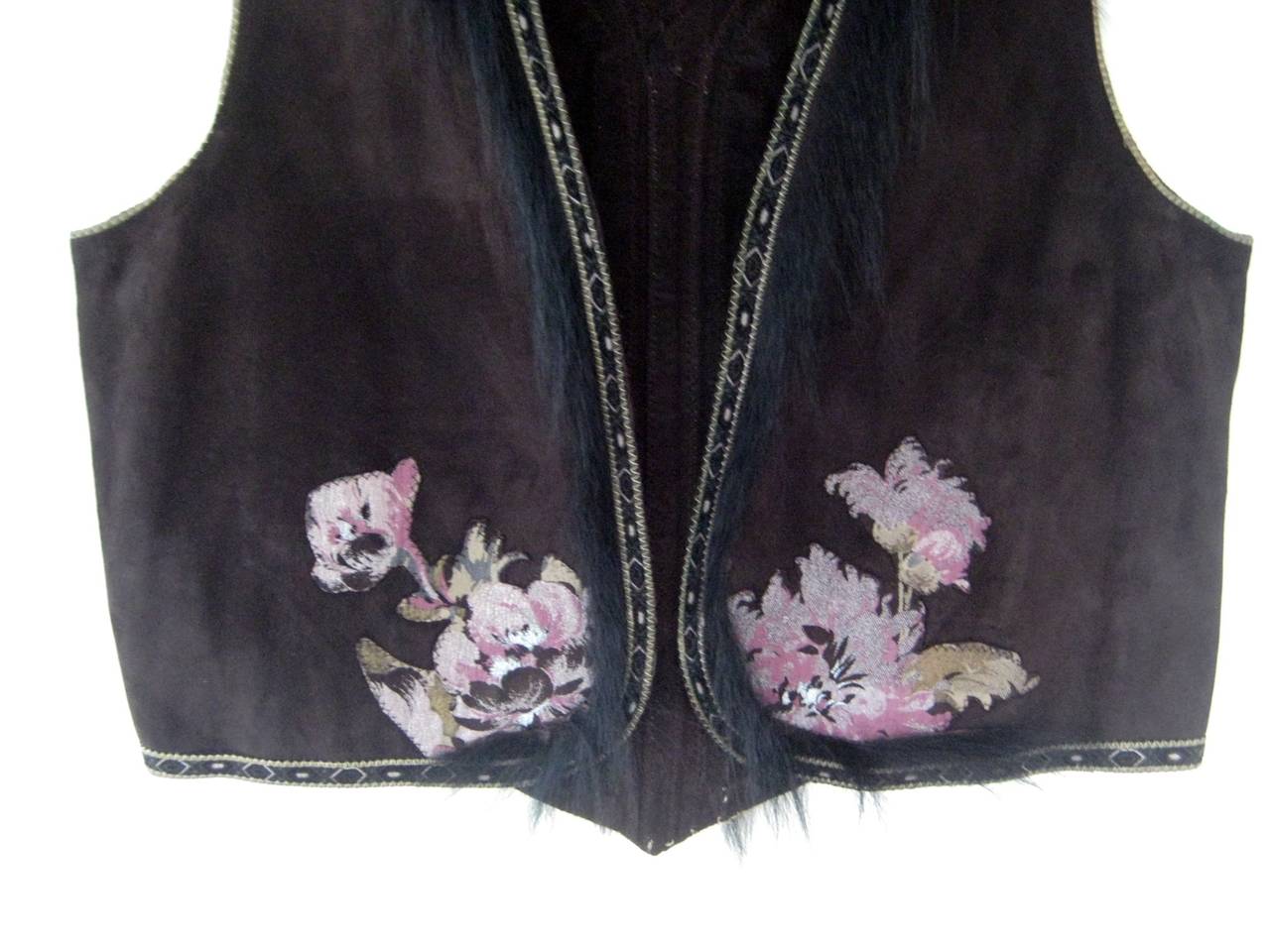 1970s Roberto Cavalli suede vest with pony hair trim , hand painted floral appliqué and snakeskin trim .
From The Ebony Fashion Fair Runway Archive Collection 
No closures
Labeled size medium
