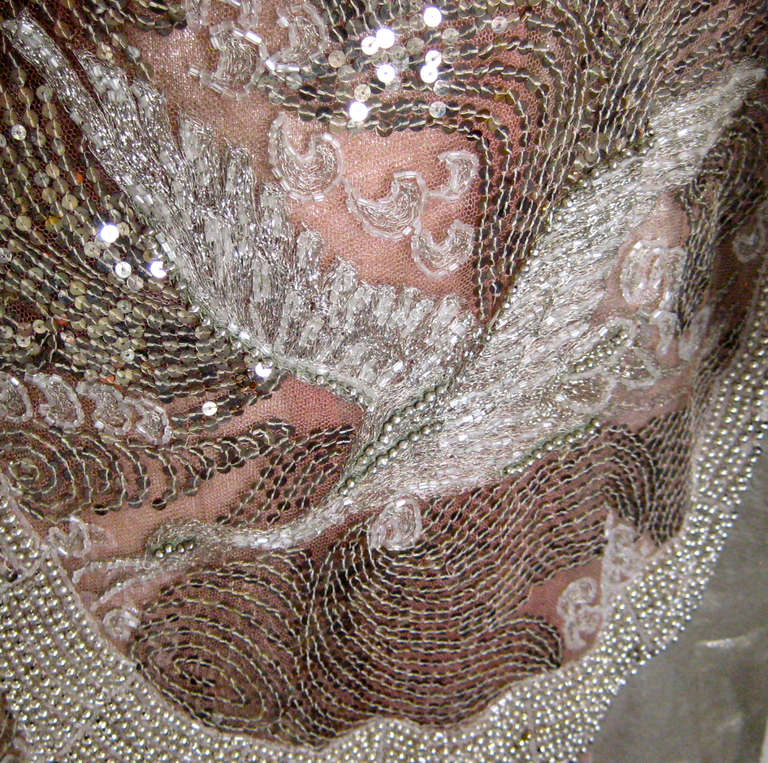 Stunning example of a french couture cocktail dress
 Silver lame sheath with scalloped hem
 Beaded and sequin rose silk net overlay with gold glass beads and beaded cranes

The silk net is tearing in places under the weight of the beads .There