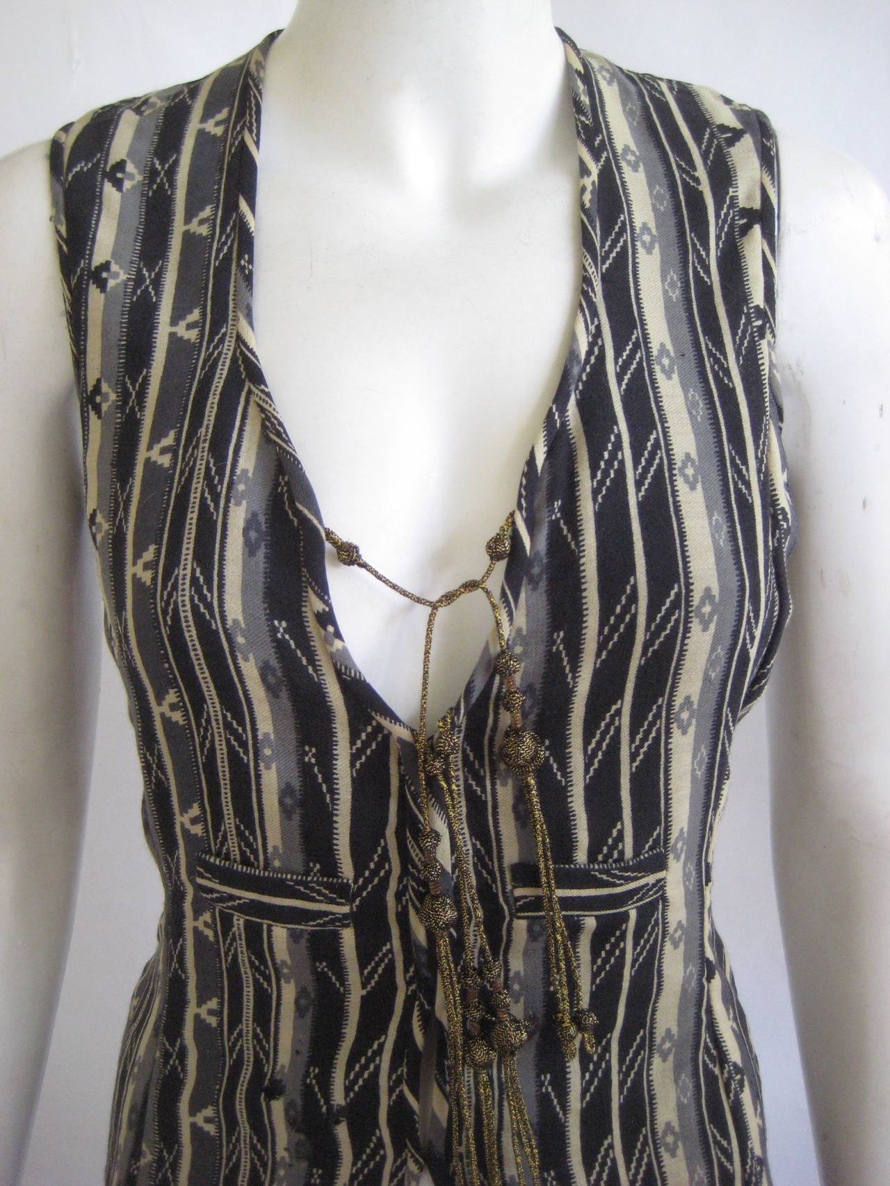 This one is a bit of a heartbreaker but I would wear it to shreds if it fit me .It is made of a fine wool ikat lined in black silk chiffon with Thea's signature gold tassels .It fastens down the front with hidden hook and eyes.I don't think it was