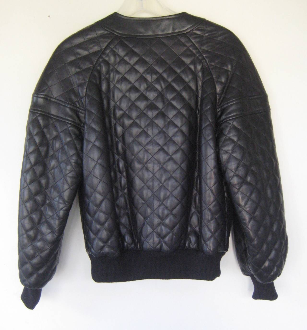 1990 Chanel quilted leather bomber jacket 
Wool knit waistband and cuffs
Logo snap buttons
Chain hem
Quilted silk linig