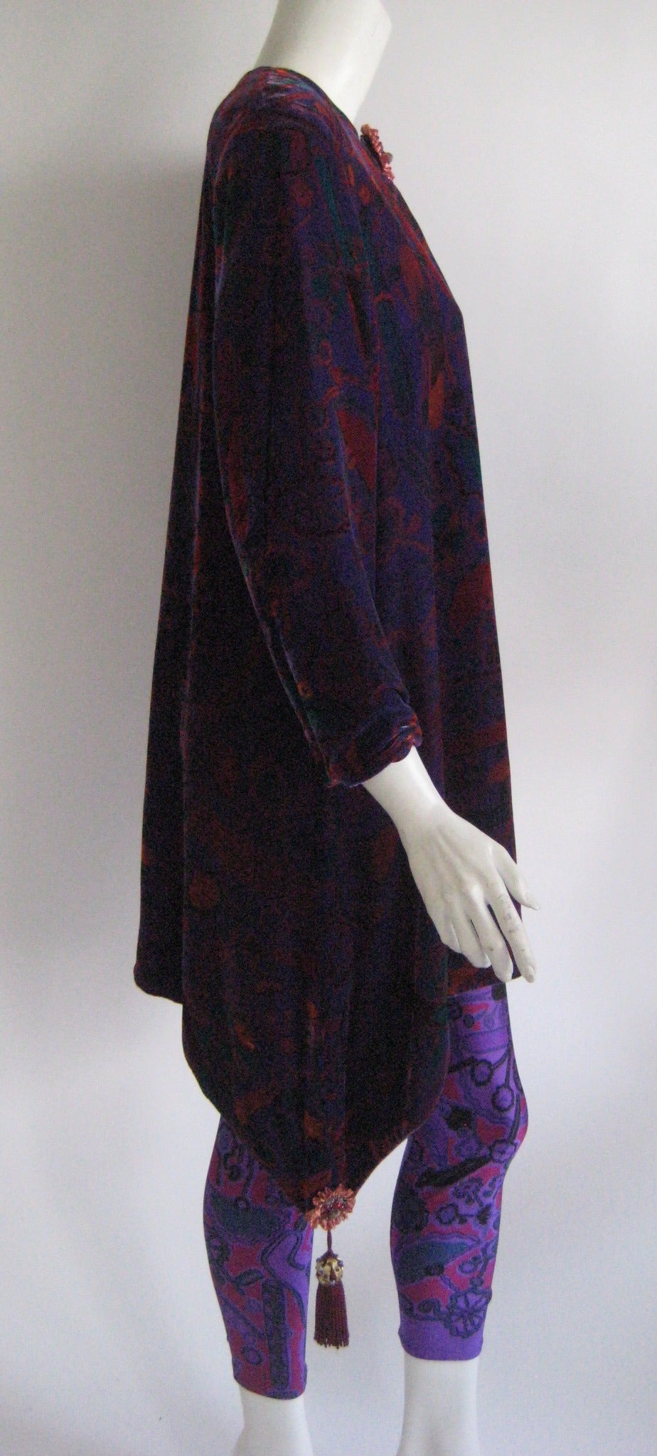 From the Ebony Fashion Fair Runway Archive comes this fabulous Zandra Rhodes velvet tunic with matching leggings .The rayon silk velvet tunic zips up the back and it is fully lined in a dull purple rayon .It has a medallion at the neckline and two