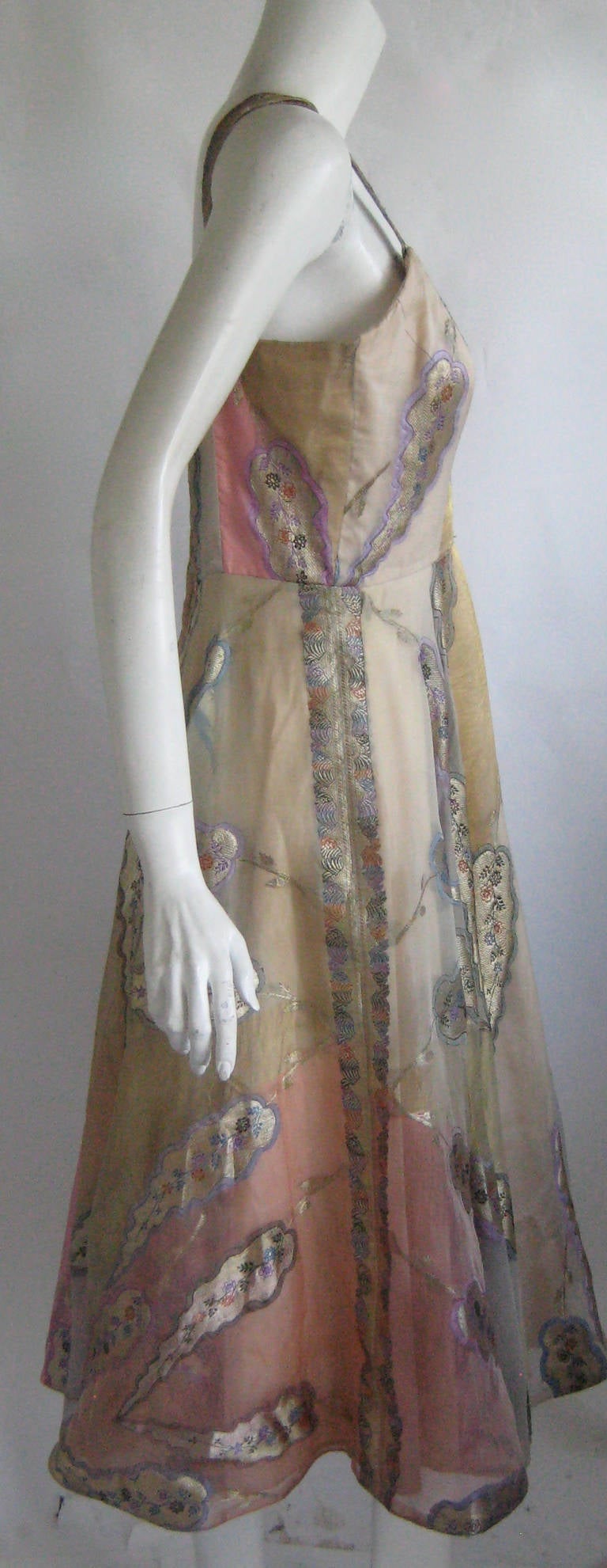 Simply stunning 1950s hawaiian dress
The prettiest we have ever seen !
Rayon taffeta underdress with multi color silk lame organza overdress
Metal zipper up the back
Good to very good condition , wearable with care  there is an 1/8 