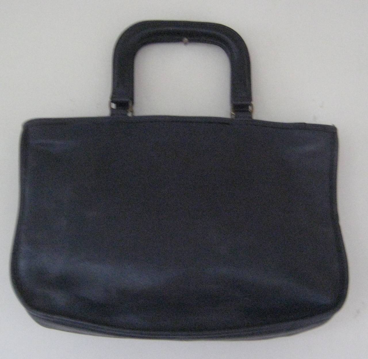 Classic Bonnie Cashin for Coach handbag 
Deep navy blue leather
Wide zipper closure
One exterior pocket 
One interior flap pocket 
This measures approx 14