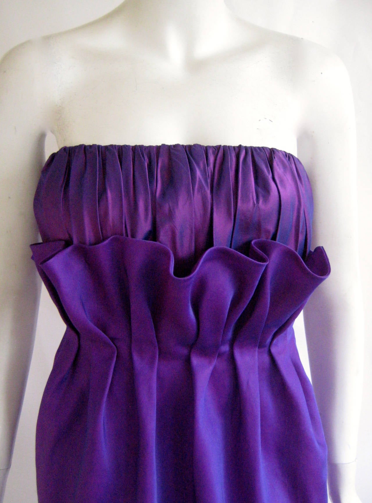 Amazing 1980s silk organza cocktail dress from fashion designer turned floral designer Carolyne Roehm.This dress looks like a flower with a finely pleated bodice and a ruffled petal overlay  .It has two zippers up one side , one that zips all the