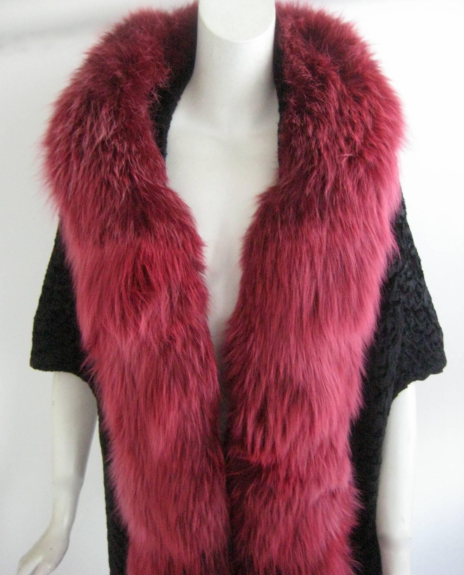 Gorgeous broadtail cape let shrug 
Lined in black silk 
Trimmed in dyed pink fox 
Excellent condition