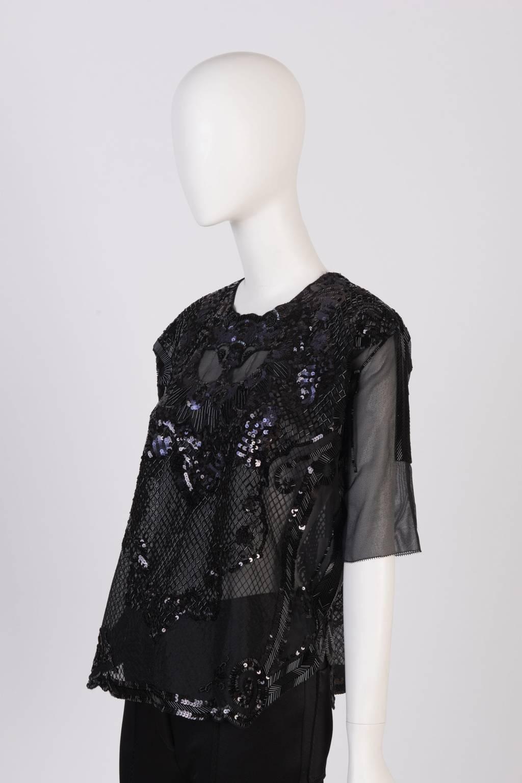 Sheer top with elbow length sleeve and Lion motif; hand embroidered with navy sequins and black bugle beads.