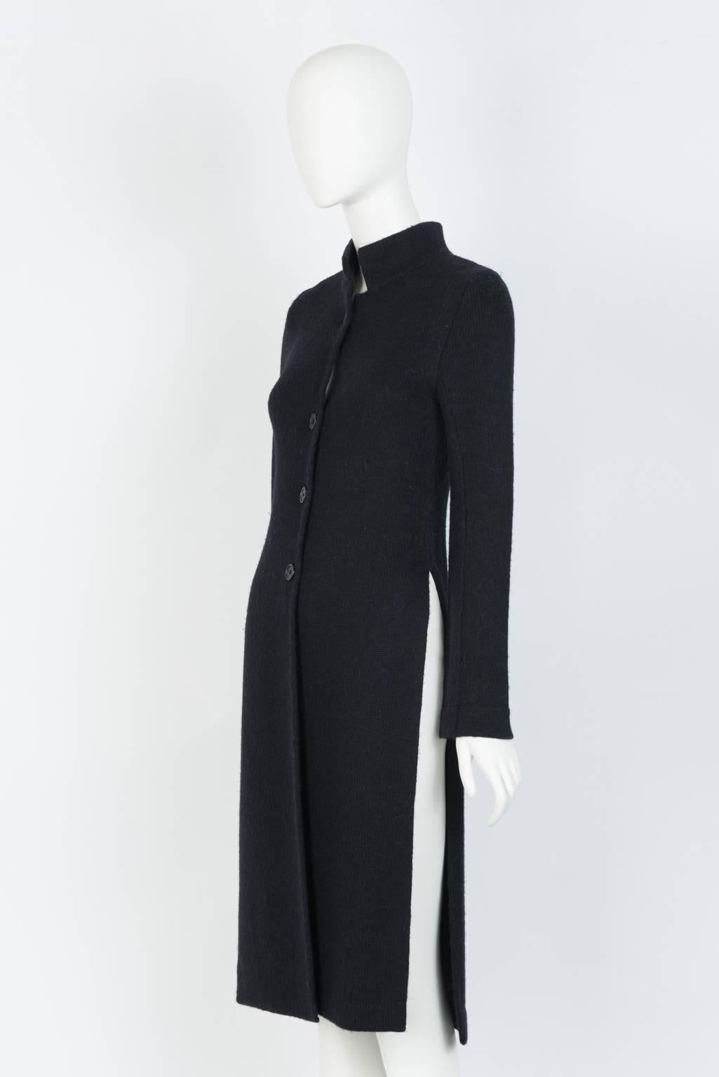Tunic-style, four button knit black coat with high side slits and Mardarin collar.