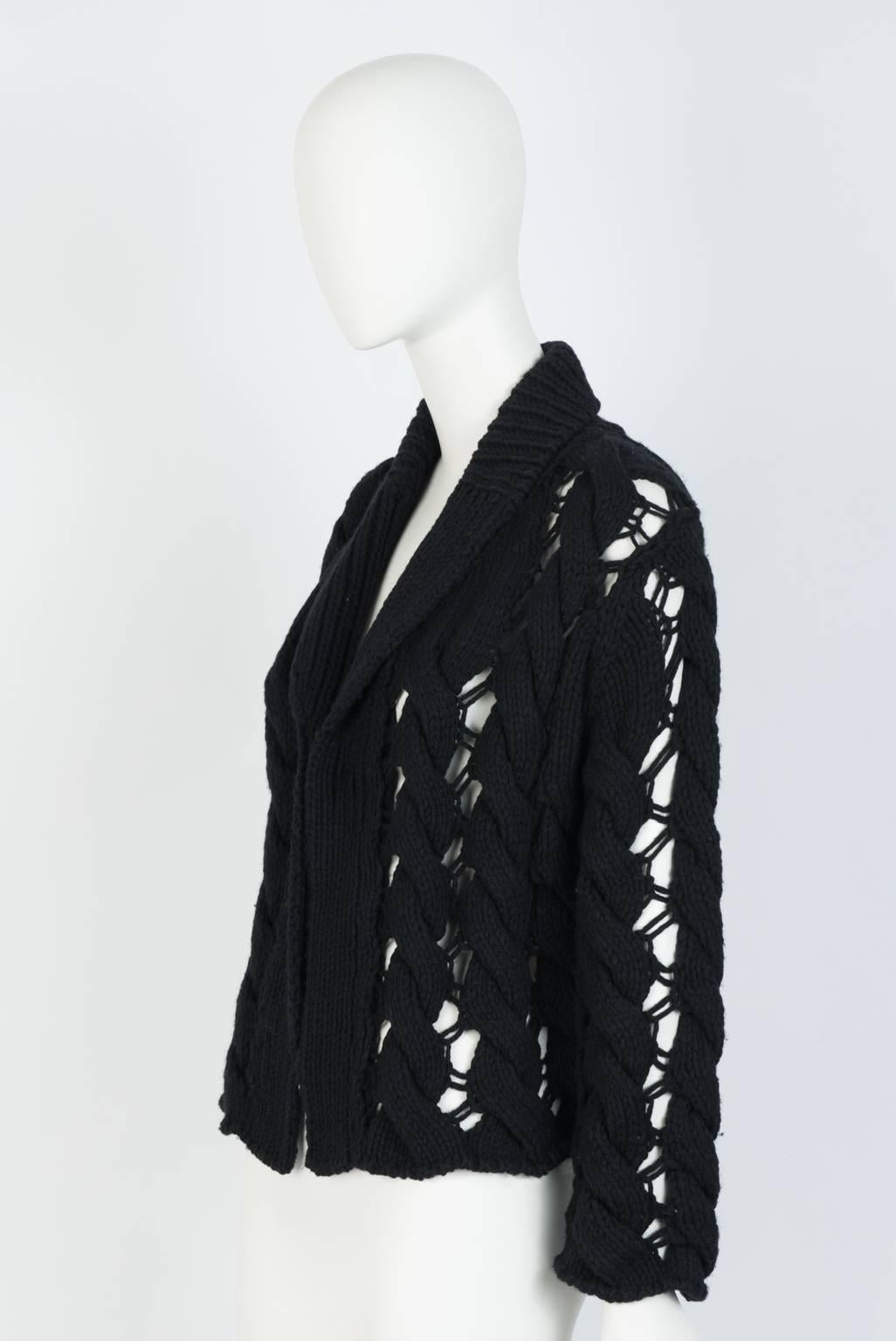 Cropped, hand knit, open weave cable cardigan with shawl collar.