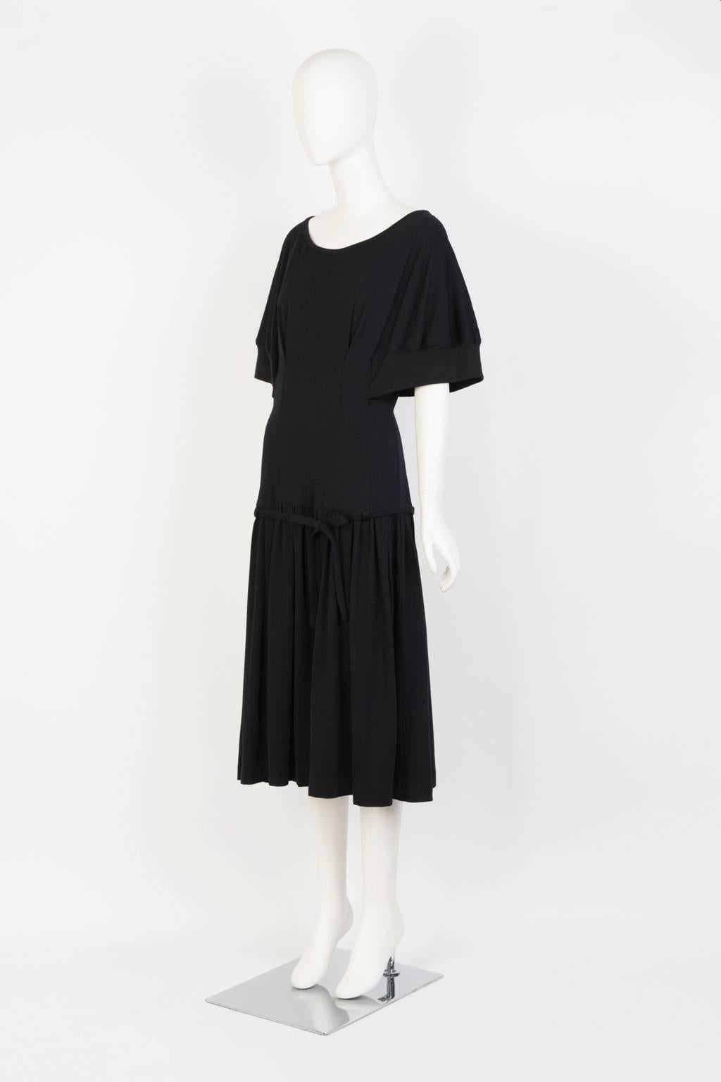 Black knee length dress in lightweight knit with kimono half sleeve and front bow detail and back zip. 