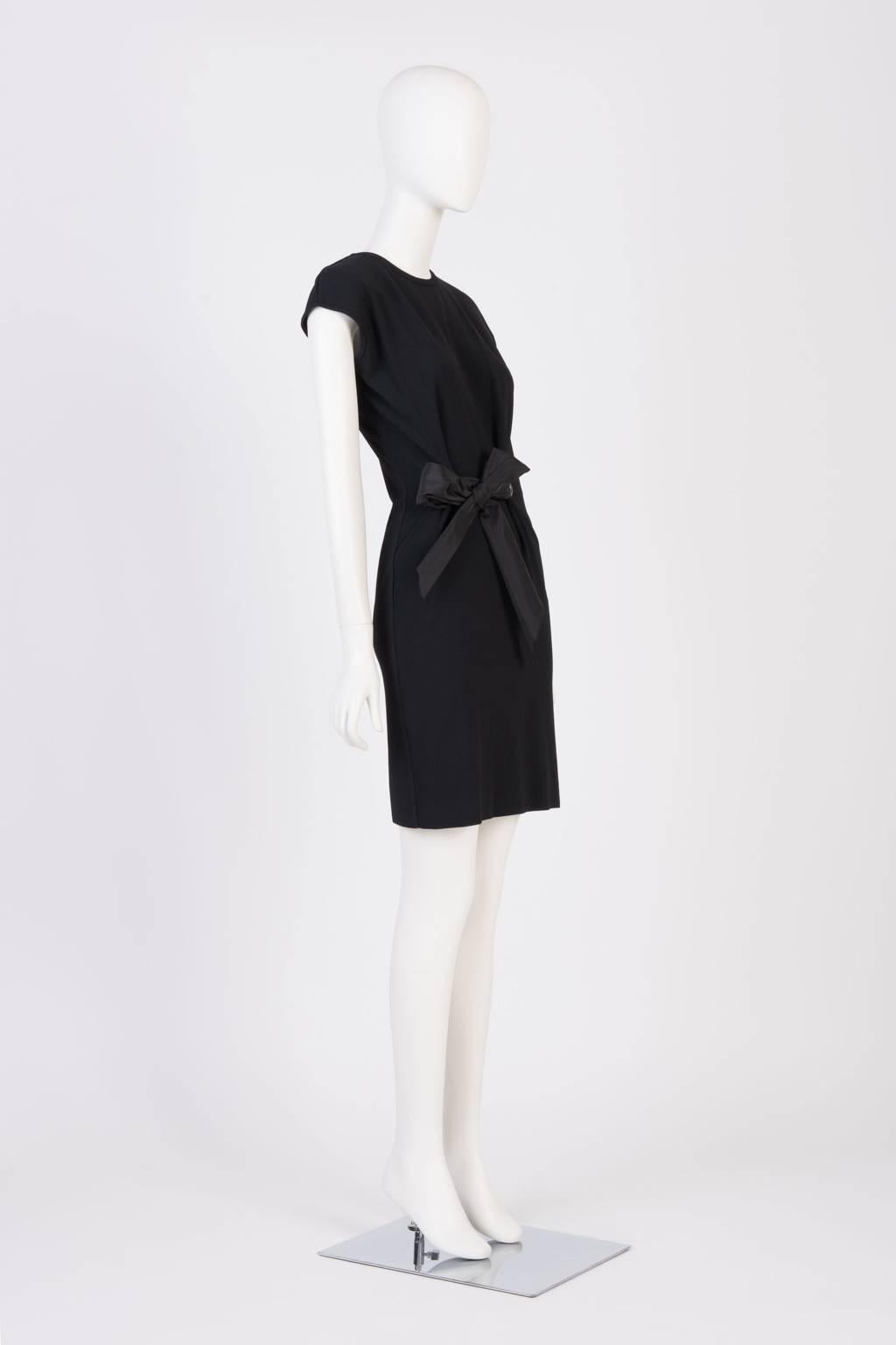 Short sleeve, knee length knit dress with rew neck and silk bow and grommet waist detailing.
