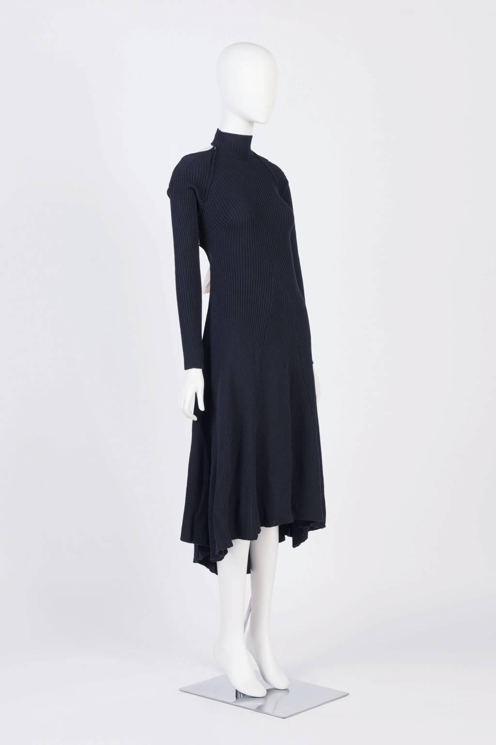 Backless, 3/4 length, turtleneck dress in ribbed wool  with ribbon bow closure.