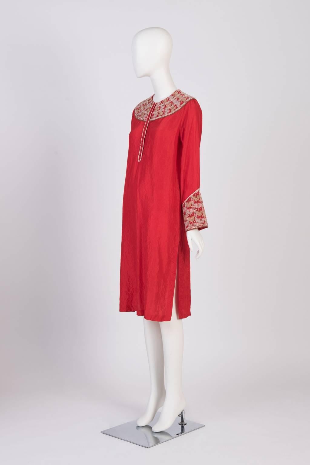 Knee length tunic dress with side slits, hand embroidered at collar and cuff.