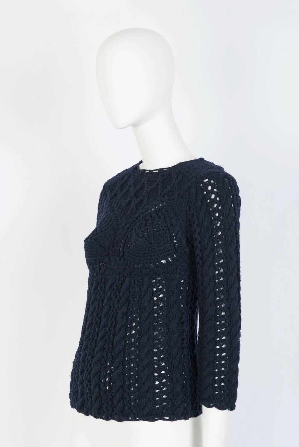 Thick crochet knit sweater with crew neck, 3/4 length sleeves, bust detailing, and back button closure.