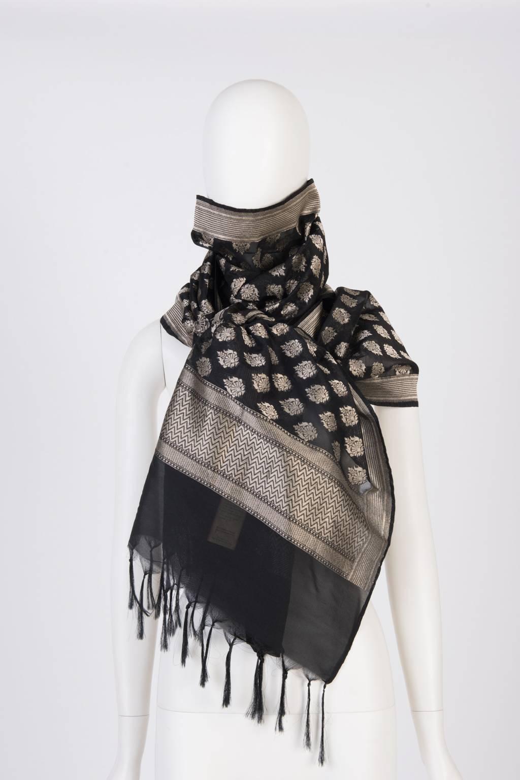 Machine woven fringe scarf with metallic deailing.