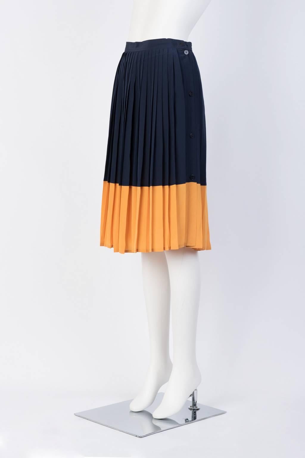 Color block silk pleated A-line skirt with button fasterning all the way down the side. 