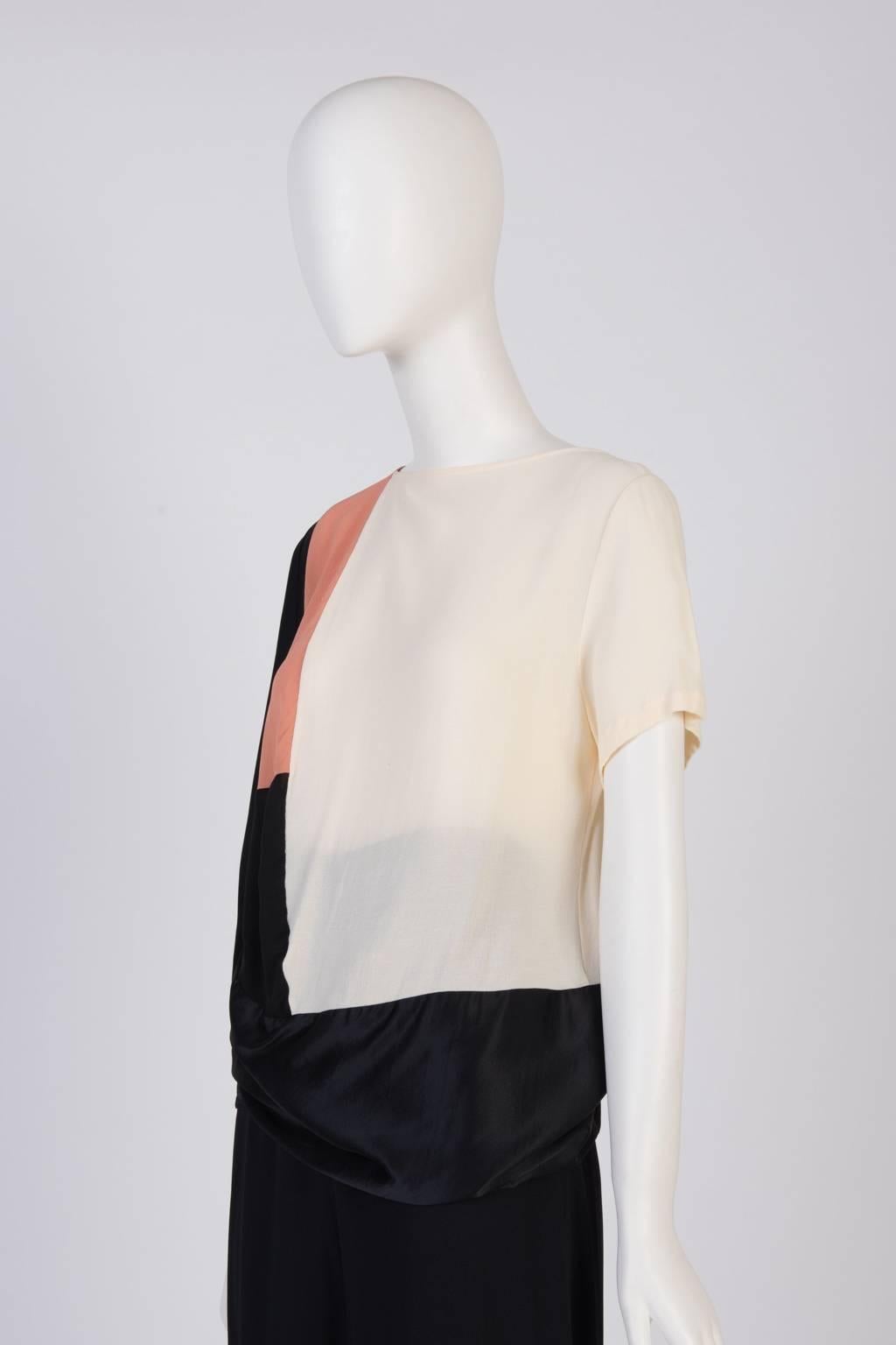 A loose fit short sleeve top with multi color panels, featuring different textures: semi sheer and satin rayon.
