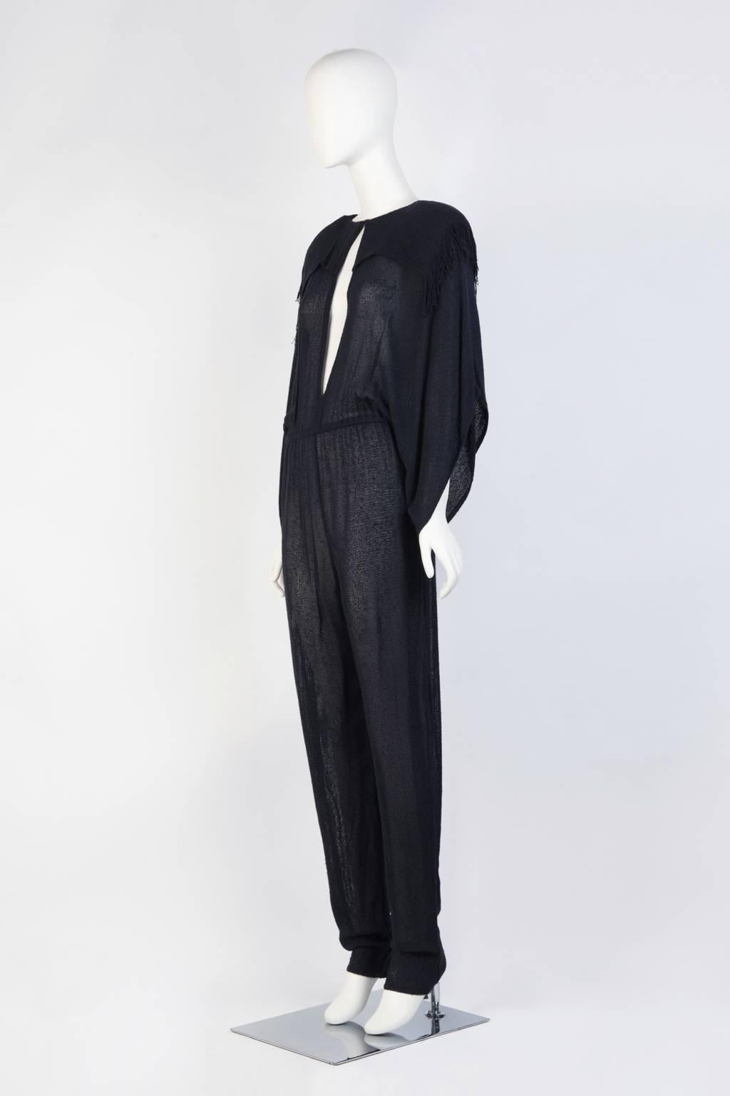  Open weave slim fit jumpsuit with loose kimono sleeves, fringed shoulder, and removable patches in navy blue. 