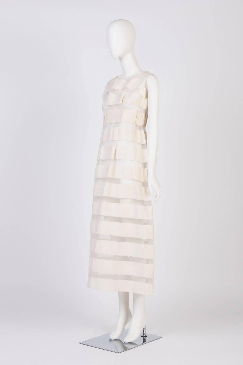 Sleeveless, eslaticated empire waist transparent dress with cotton stripes.