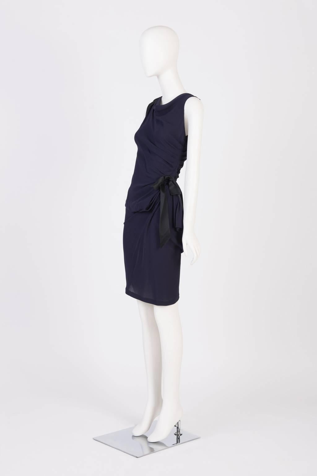 Sleeveless, knee length cocktail dress in bias cut purple silk crepe with bow detail on one shouder and side waist.  